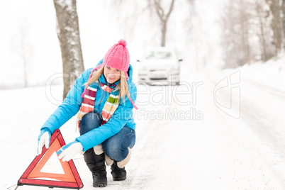 Woman put warning triangle car breakdown winter