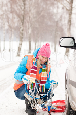 Woman with tire chains car snow breakdown