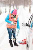 Woman holding car chains winter tire snow
