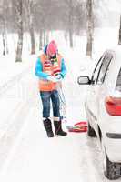 Woman holding car chains winter tire snow