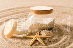 Spa body cream seashell star on sand