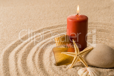 Spa setting candle with oil seashell star