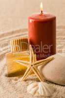 Spa setting candle with oil seashell star