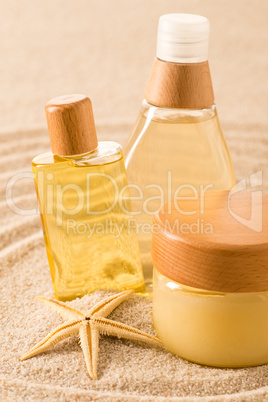 Summer care body product on sand seashell