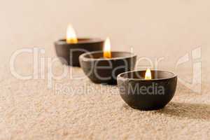 Spa therapy three candles on sand