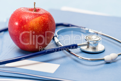 Red apple and medical stethoscope heathcare