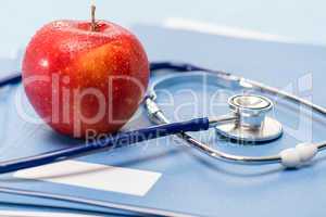 Red apple and medical stethoscope heathcare