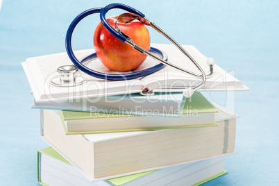 Red apple and medical books stethoscope