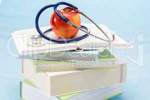 Red apple and medical books stethoscope