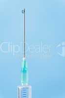 Medical syringe drop falling from needle
