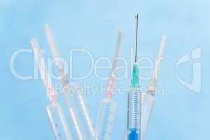 Syringes with liquid drop falling from needle