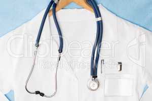 Medical lab coat hanging on hanger stethoscope