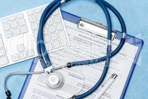 Stethoscope laying over doctors emergency report
