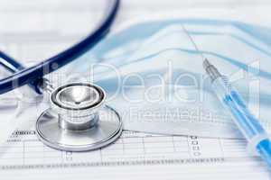Stethoscope with injection on medical report