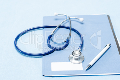 Stethoscope and pen over medical chart