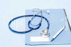 Stethoscope and pen over medical chart