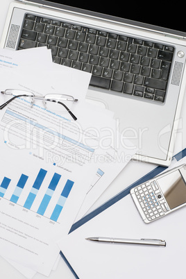 Business accessories stacked chart phone laptop