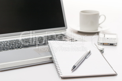 Business workplace pen notepad laptop phone coffee