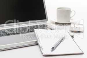 Business workplace pen notepad laptop phone coffee