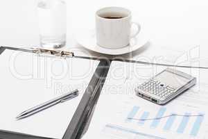 Business notepad phone and cup of coffee