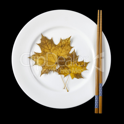 Plate with chopsticks and maple leaves