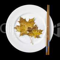 Plate with chopsticks and maple leaves