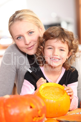 Girl decorating pumpkin