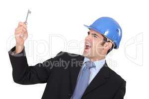 Delighted businessman in a hardhat with a doorkey