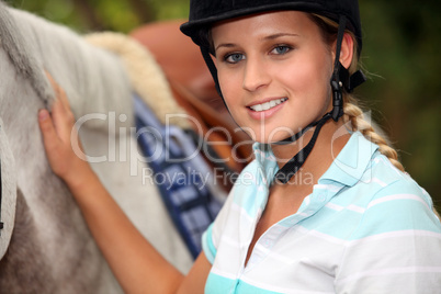 A horseback rider with her horse