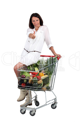 woman with supermarket trolley woman with supermarket trolley