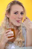Woman tasting honey