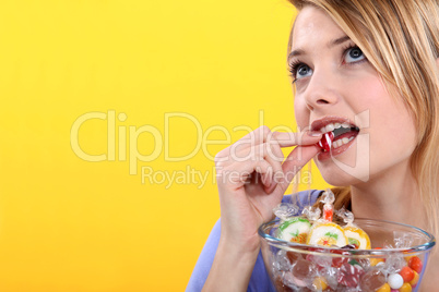 A woman enjoying candies.