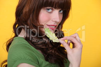Woman with a salad leaf