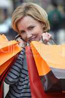 Woman holding up shopping bags
