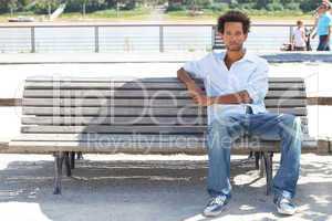 Young man sitting on a public bench