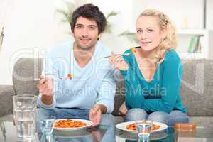 couple sat eating pasta