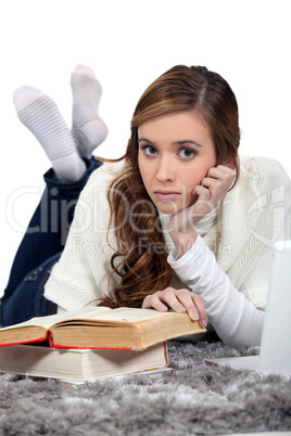 Woman reading book on the floor