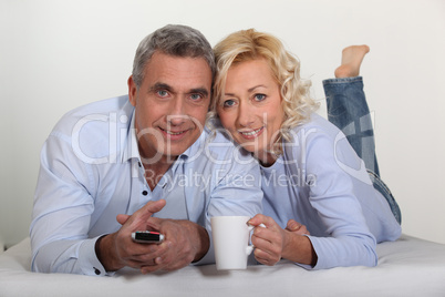 Middle-aged couple watching television