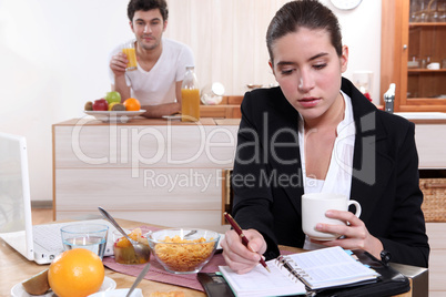 Couple eating breakfast separately