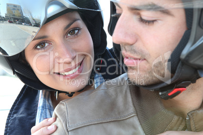 Smiling couple on a motorbike