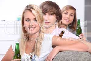 Three teenagers drinking beer
