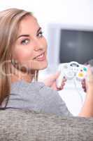 A cute blond playing video games.