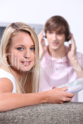 Teenagers listening to music in the living room