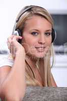 A blond woman wearing headphones