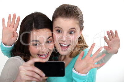 Two girls posing with camera phone