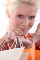 Closeup of a young blond woman carrying shopping bags