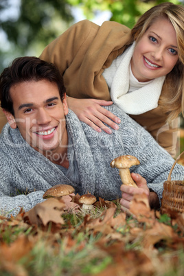 Couple picking wild mushrooms