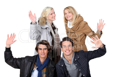 two young couples posing together