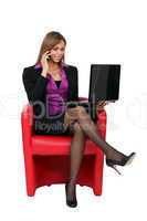 Businesswoman sitting in chair with laptop