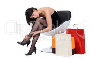 Women sat surrounded by shopping bags